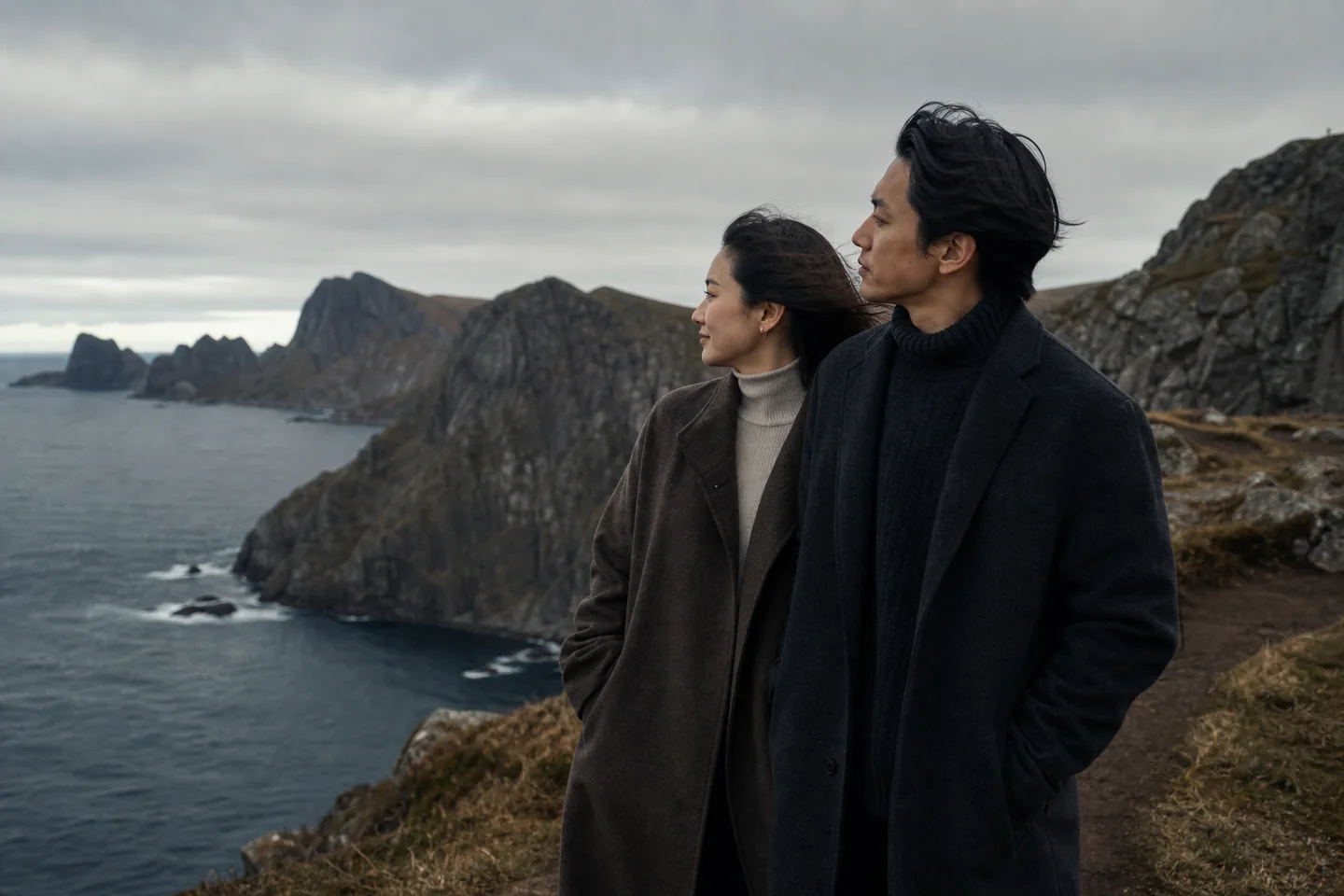 Couple portrait on an overcast Lofoten coastal cliff