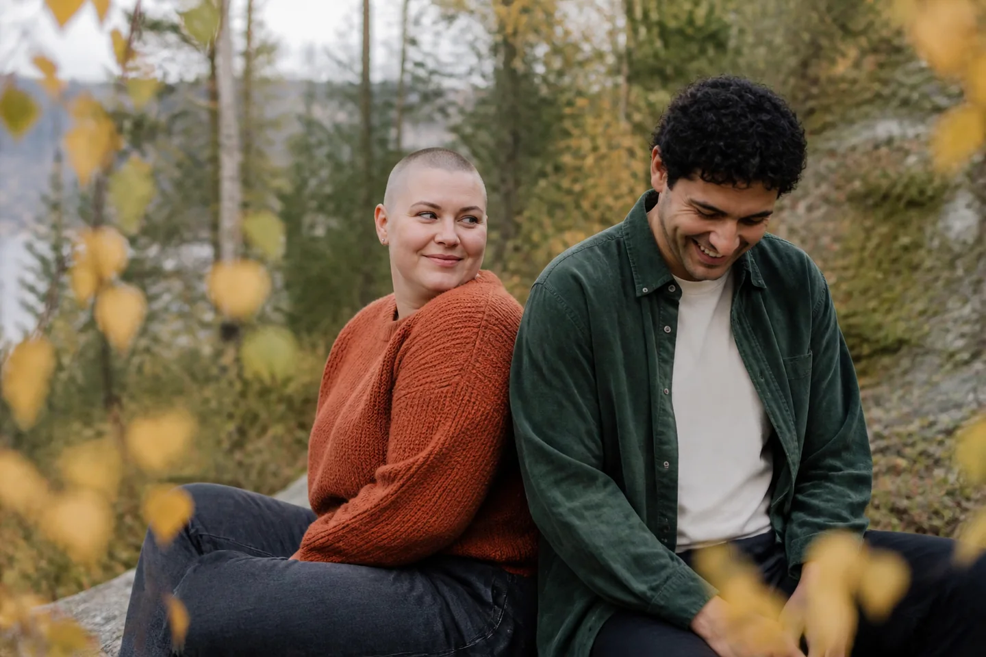 Relaxed autumn couple portrait among coastal birch trees in Tromsø
